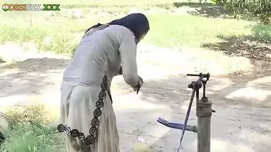 Young village school girl taking a bath in a sari and caught on camera