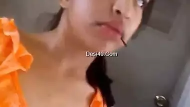 Indian babe in orange takes clothes off to flaunt boobs and buttocks